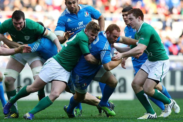 Gonzalo Garcia of Italy (C) is tackled during the RBS Six Nations match between Italy and Ireland 