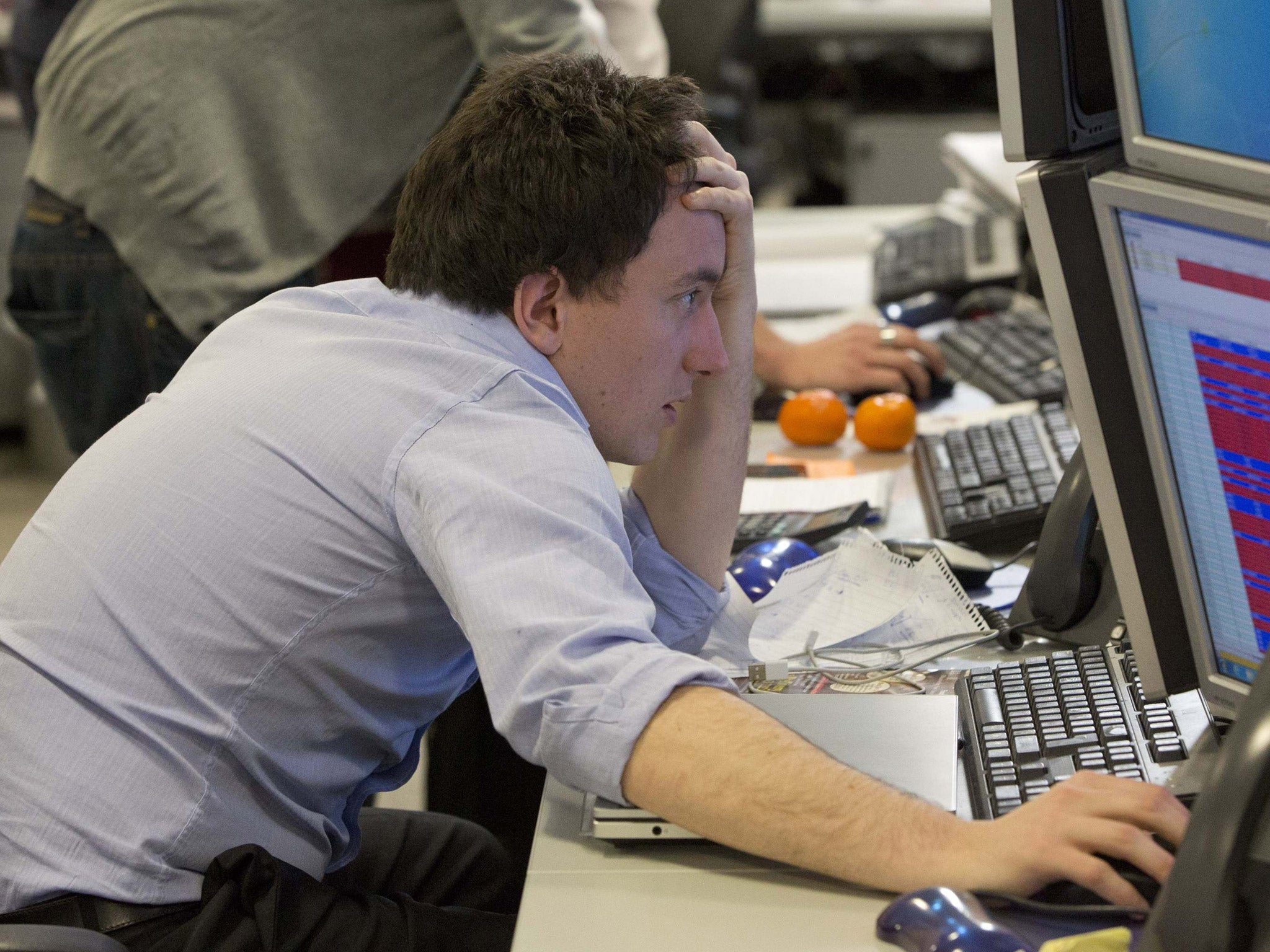A trader looks at his screen on the IG Group trading floor in London