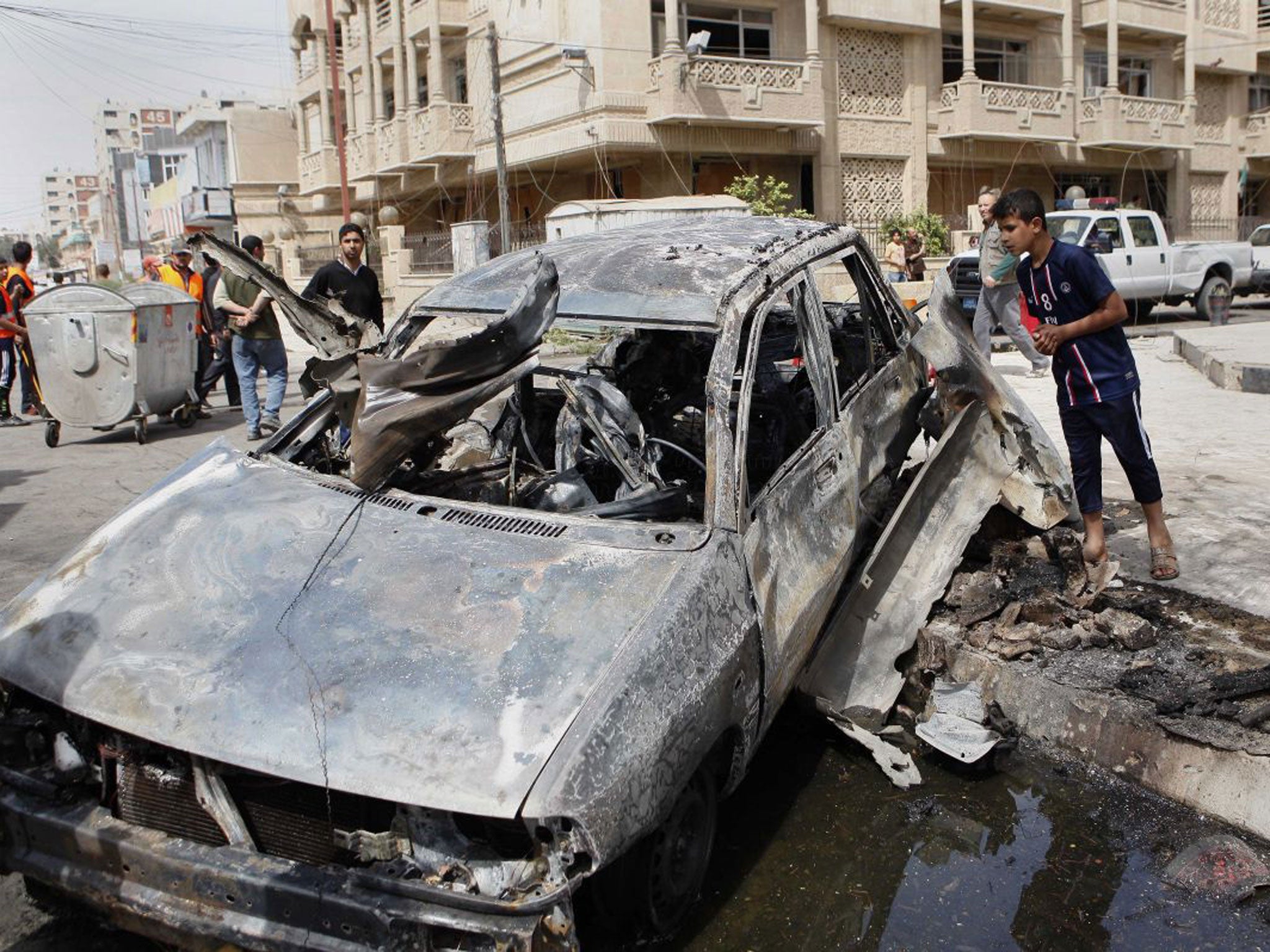 A car destroyed in an attack close to the Green Zone in Baghdad