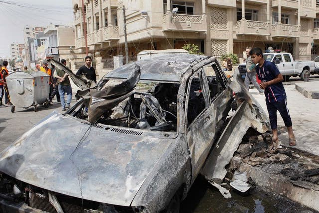 A car destroyed in an attack close to the Green Zone in Baghdad