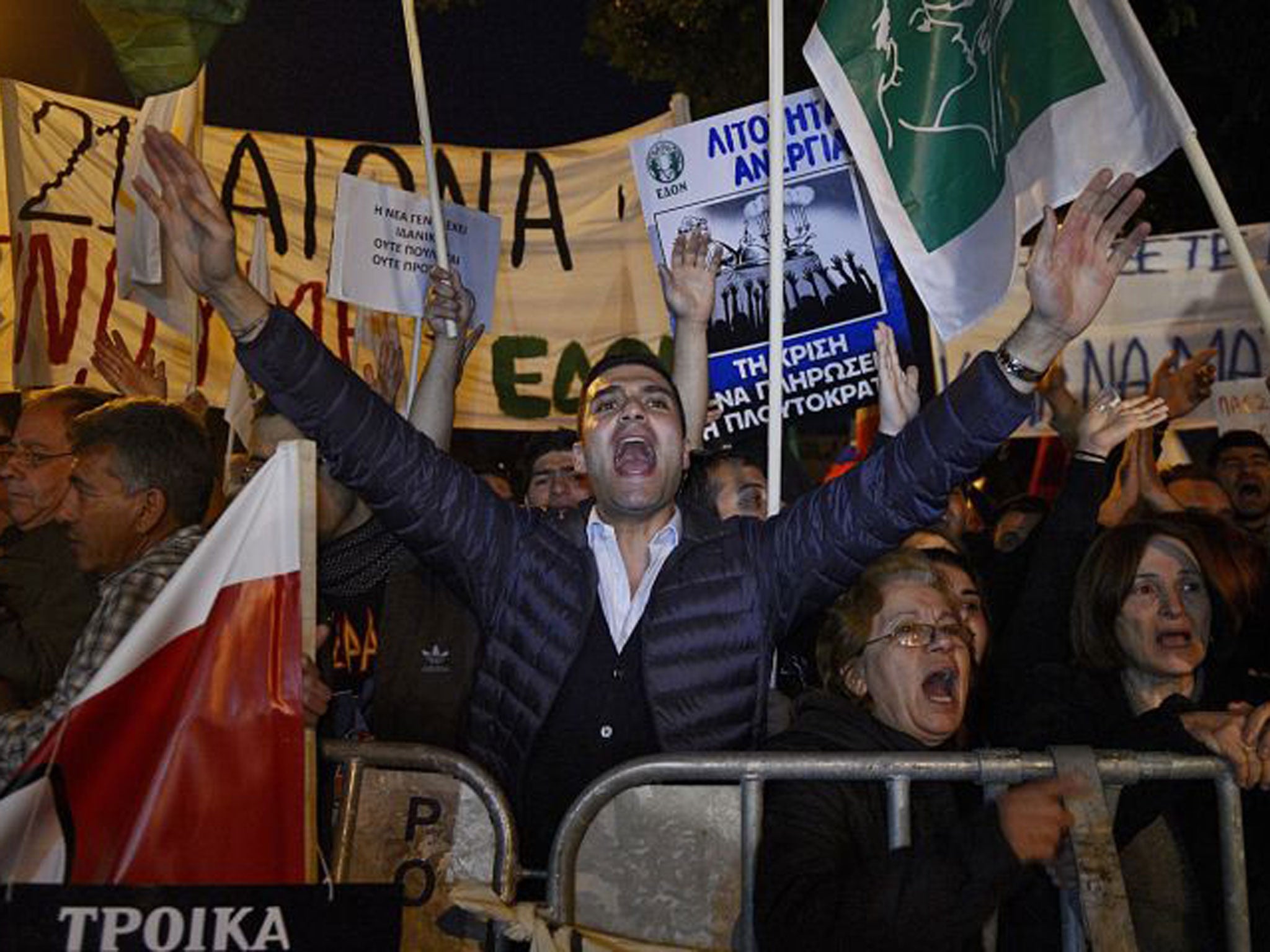 Protestors shout slogans during a rally against a tax levy on deposits