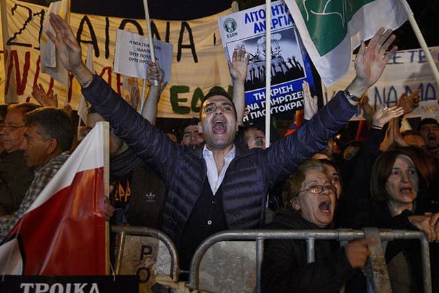 Protestors shout slogans during a rally against a tax levy on deposits