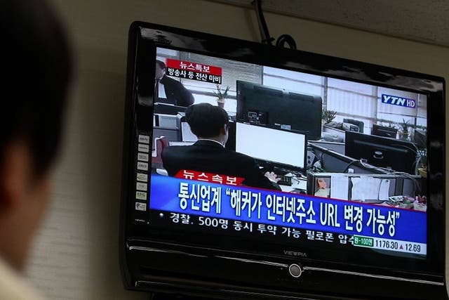 A man watches breaking news on computer failures, in Seoul, South Korea