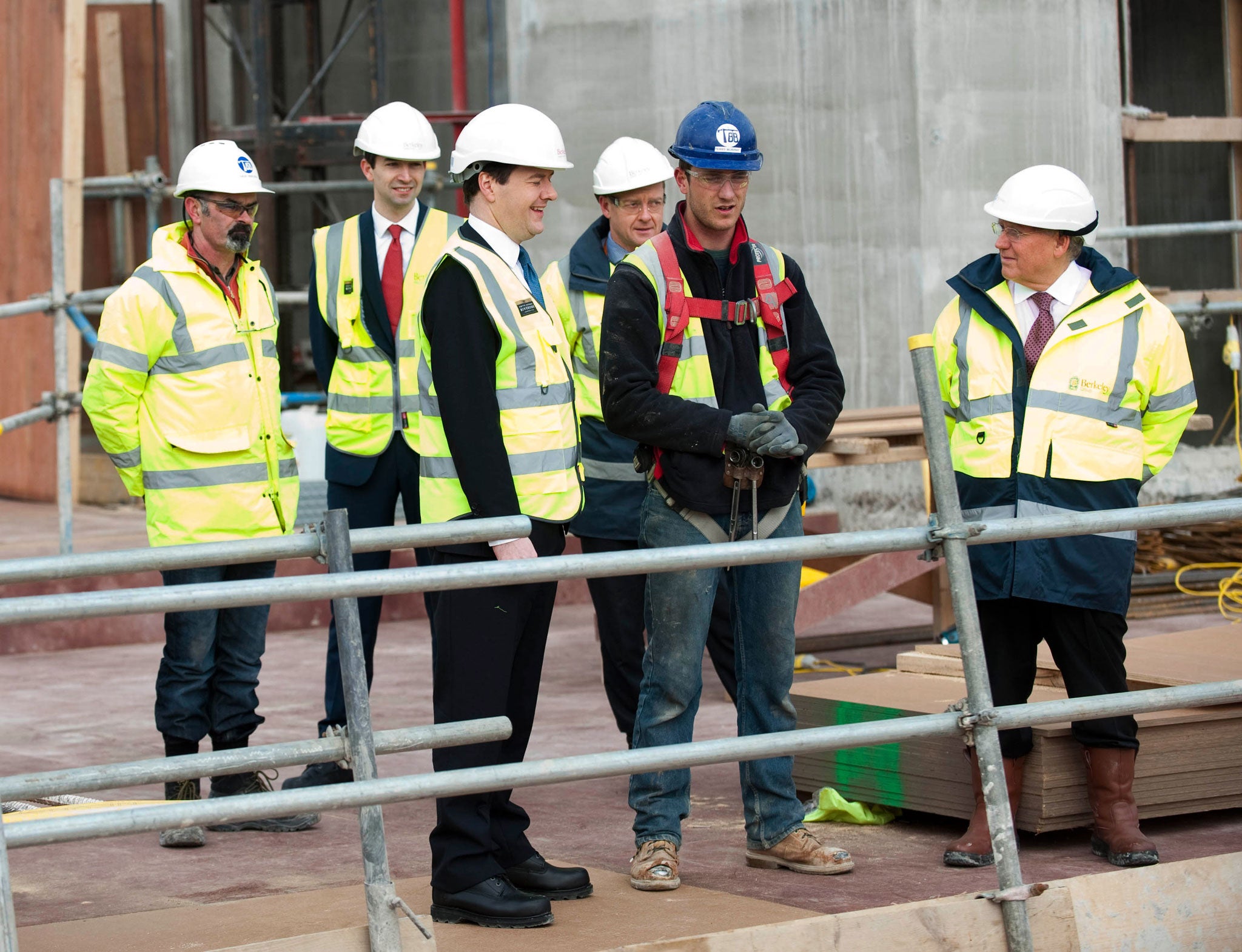 Chancellor George Osborne speaks to construction workers during a visit to the Berkeley Homes Royal Arsenal Riverside development in Woolwich, south London