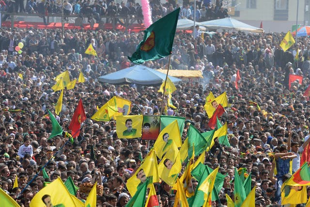 Thousands of PKK wave images of jailed Kurdish rebel leader Abdullah Ocalan in the southeastern Turkish city of Diyarbakir today