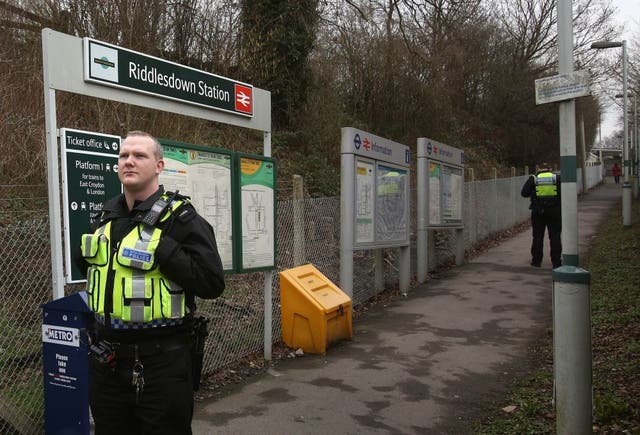Police at Riddlesdown railway station near Purley, South London where a woman and a young boy, believed to be three years old, died today when they were hit by a main line train in the morning rush hour