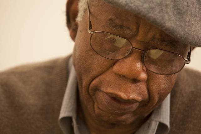 Chinua Achebe writing in his office at Brown University in 2012