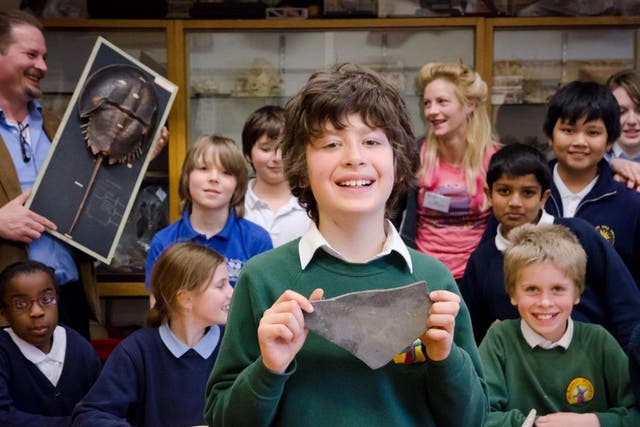 Bruno Debattista holding his fossil, and the rest of the Natural History Club in the background, with Chris Jarvis, left, holding a specimen of a fully grown horseshoe crab