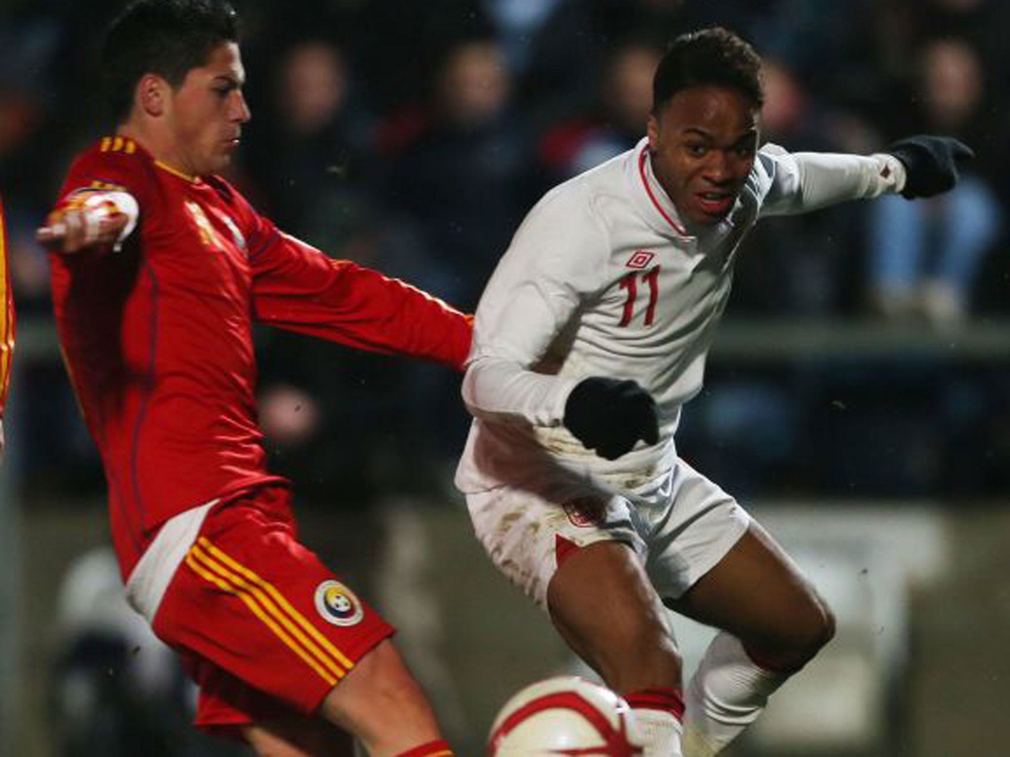 Raheem Sterling is challenged during the 3-0 win over Romania