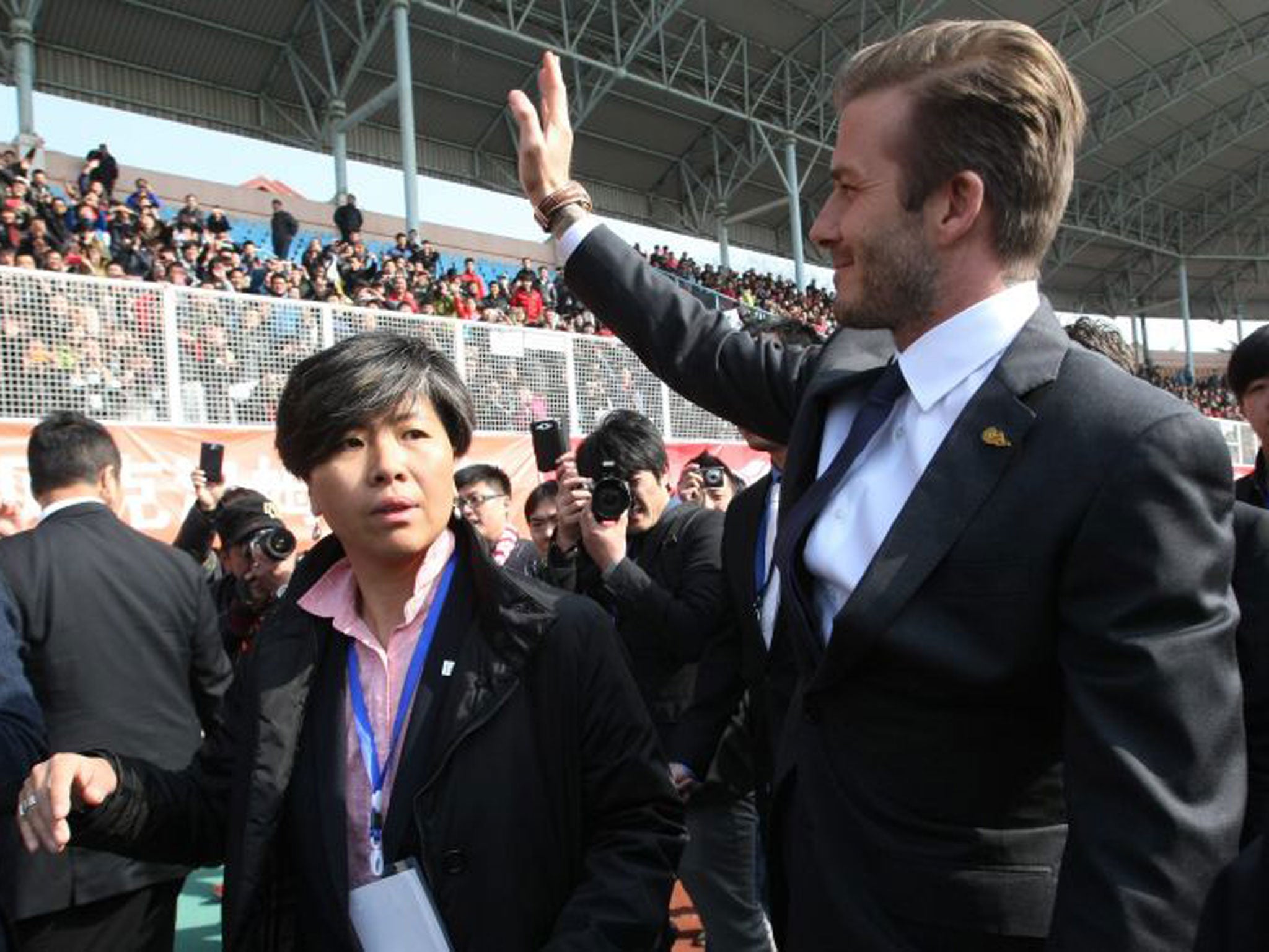 Young fans in Qingdao crowd to snap David Beckham – who plays it strictly formal