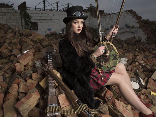 Second wind: Musician Ruby Fenn plays a lyre made from a Second World War helmet