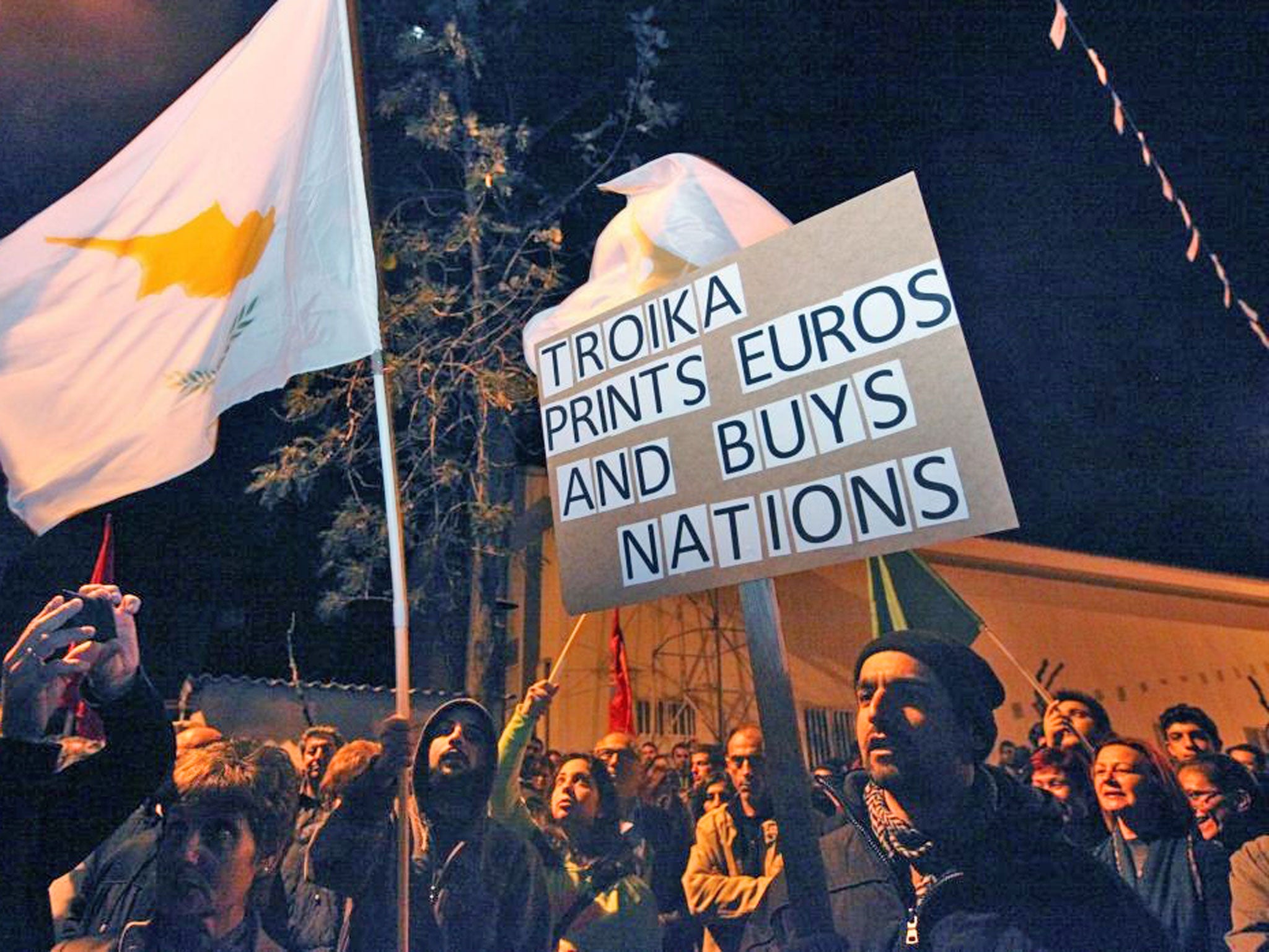 People protest against the bailout in front of the European Union House building in Nicosia