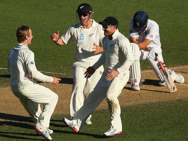 Kane Williamson, Brendon McCullum and Hamish Rutherford of New Zealand celebrate the wicket of Alastair Cook
