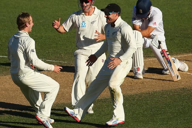 Kane Williamson, Brendon McCullum and Hamish Rutherford of New Zealand celebrate the wicket of Alastair Cook