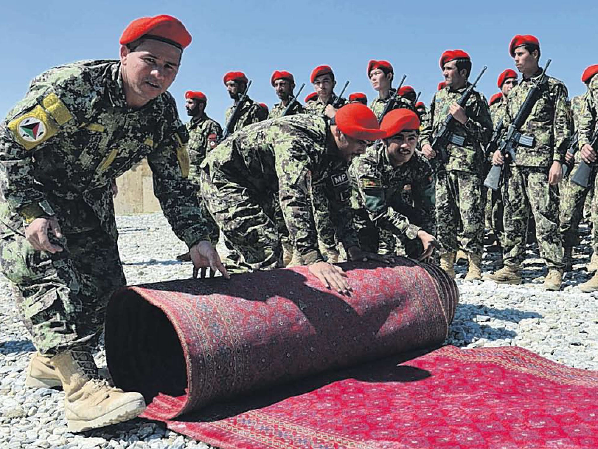 Afghan soldiers roll out a red carpet before a ceremony to hand over Bagram prison to AfghanistanAfghan soldiers roll out a red carpet before a ceremony to hand over Bagram prison to Afghanistan