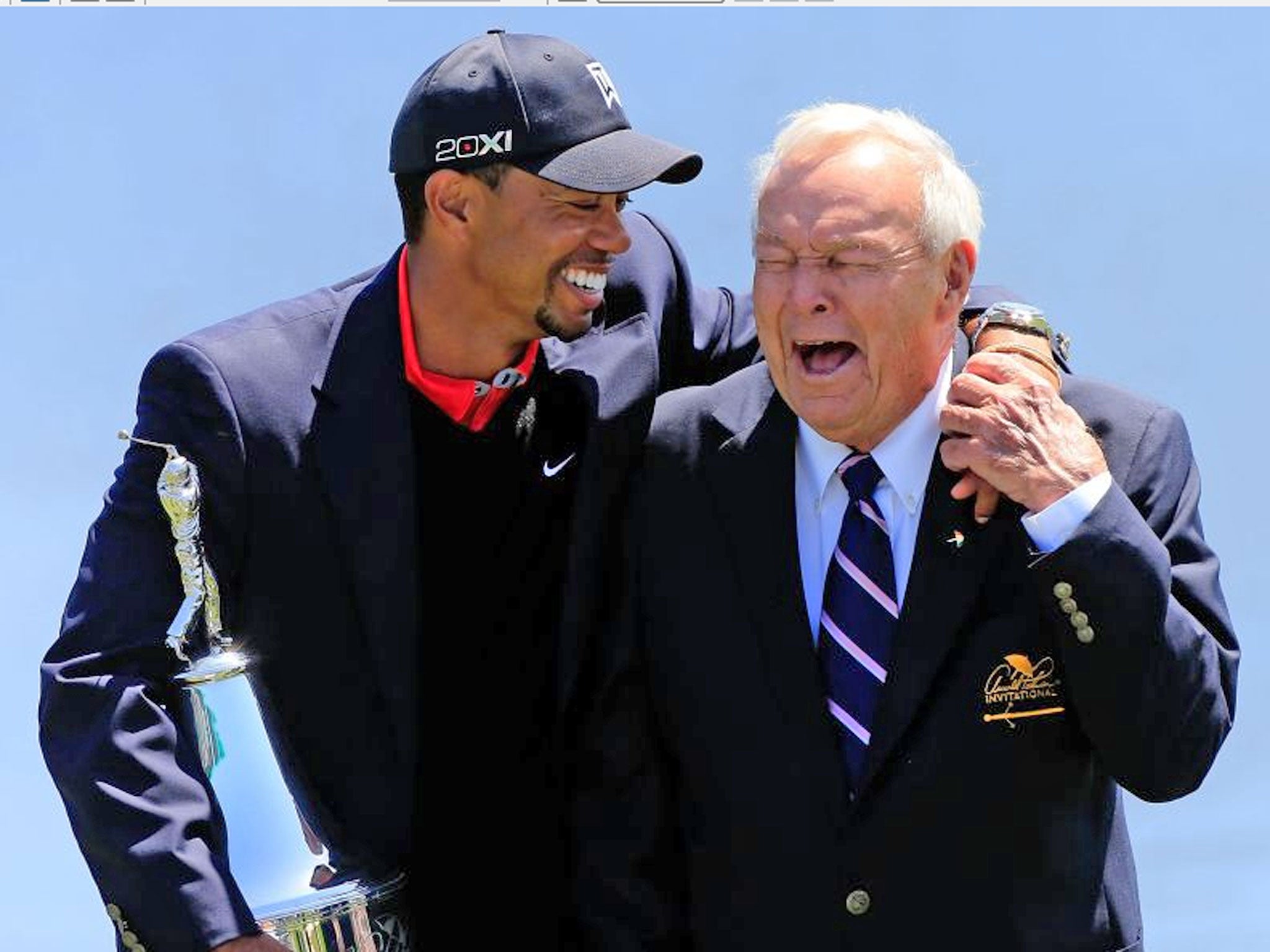 Tiger Woods gets a laugh out of Arnold Palmer at the trophy presentation yesterday