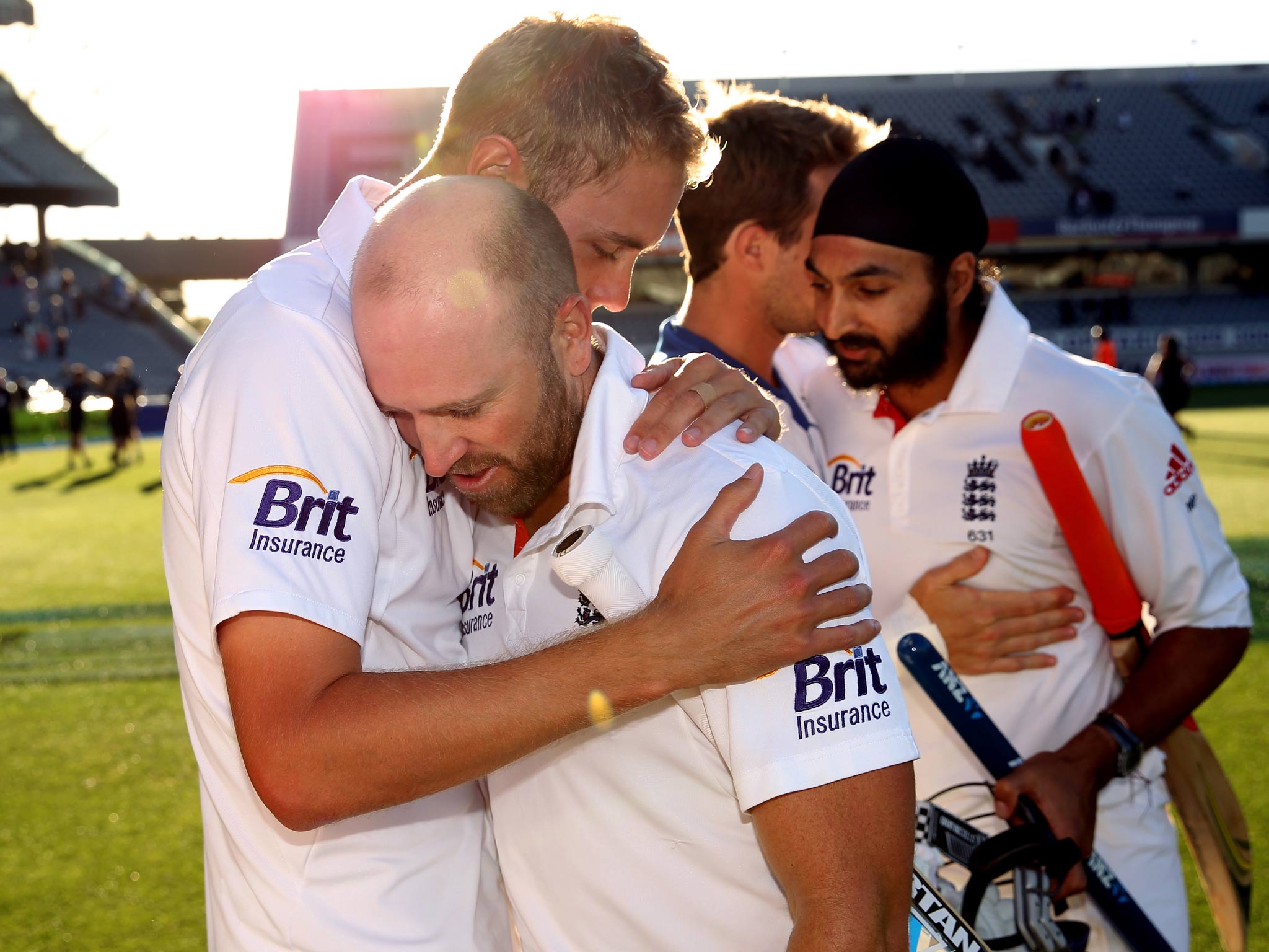 Matt Prior of England is hugged by Stuart Broad as he leaves the field with Monty Panesar at the end of day five of the Third Test match against New Zealand