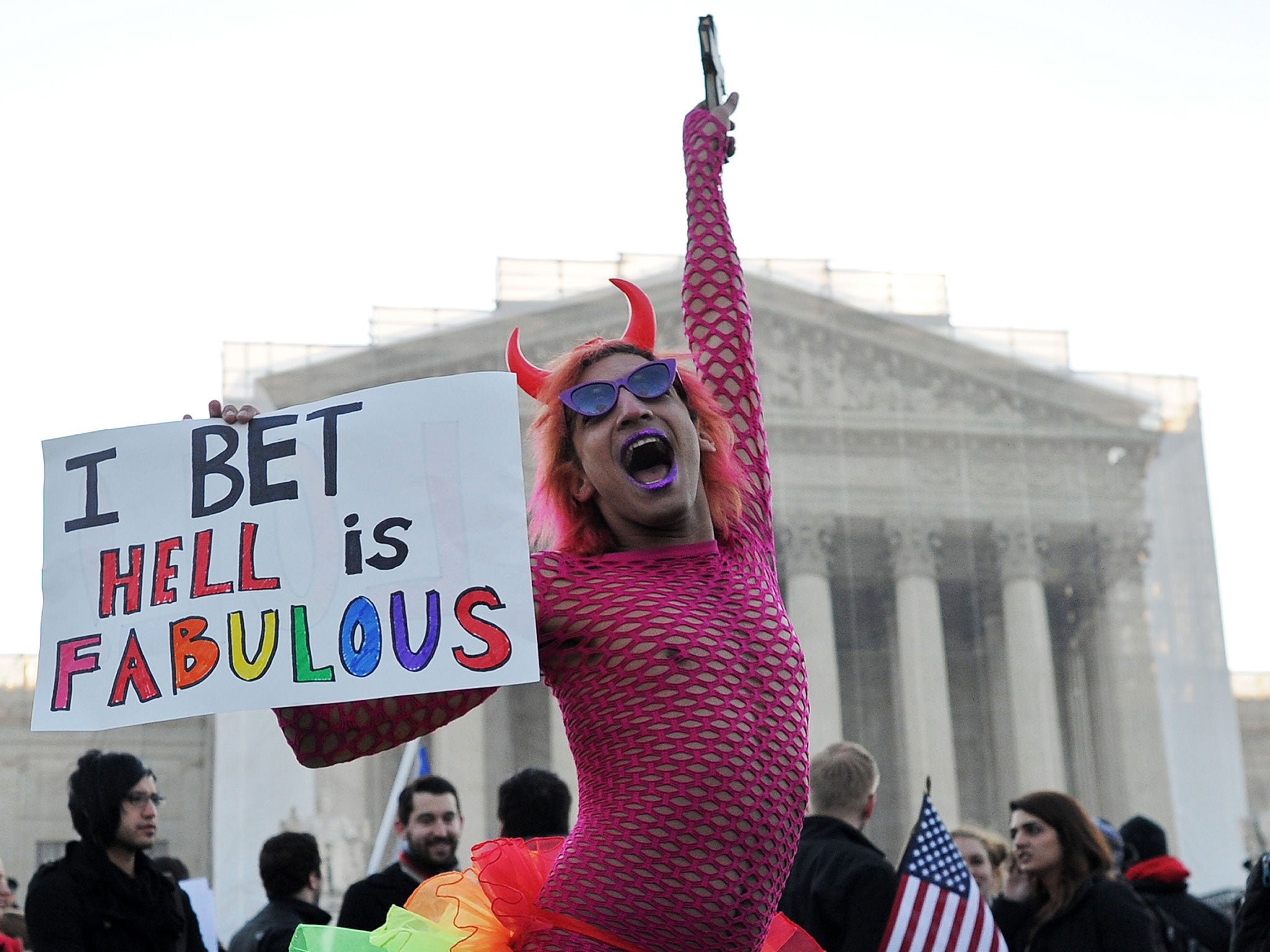 A gay supporter dances in front of the US Supreme Court