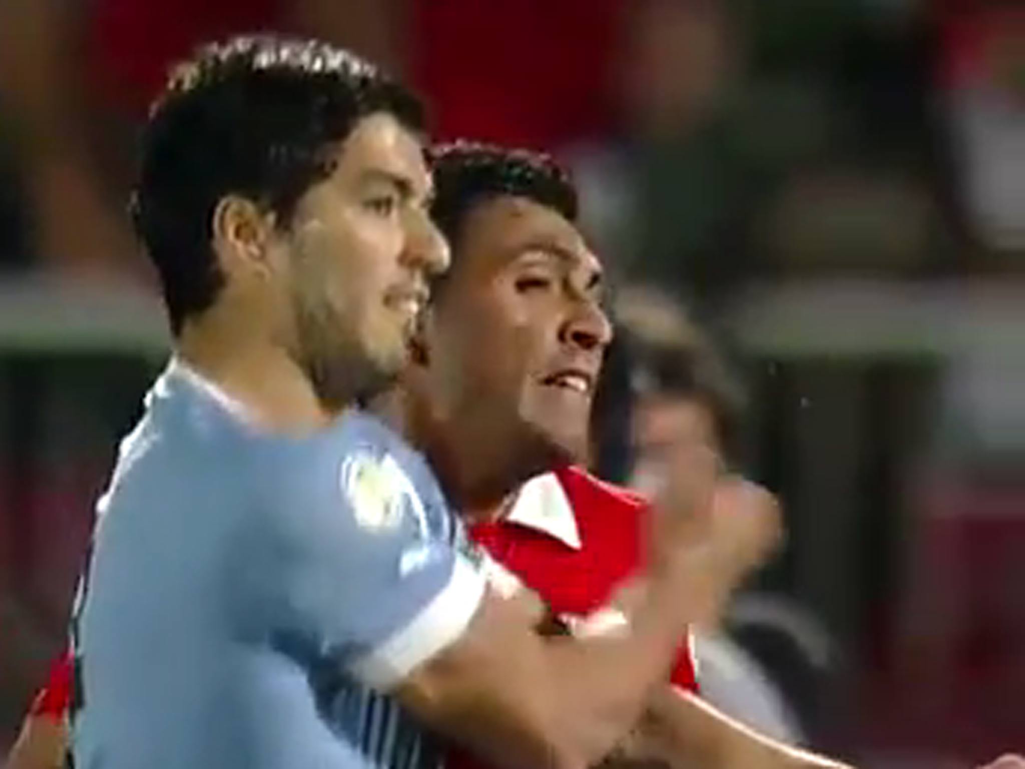 Suarez punches Gonzalo Jara during Uruguay's defeat against Chile