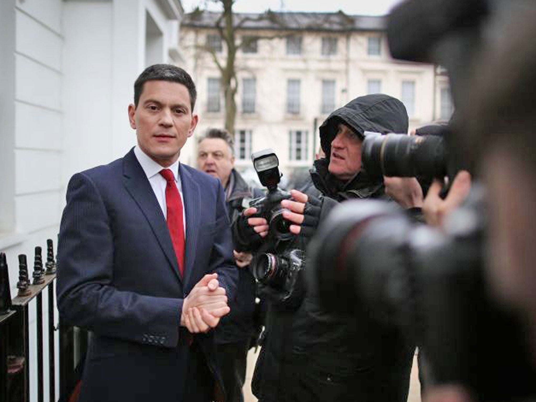 Former Foreign Secretary David Miliband talks to reporters at his home in London, England