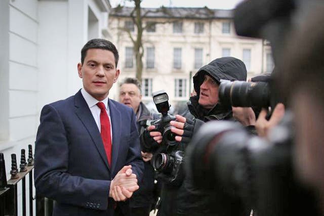 Former Foreign Secretary David Miliband talks to reporters at his home in London, England