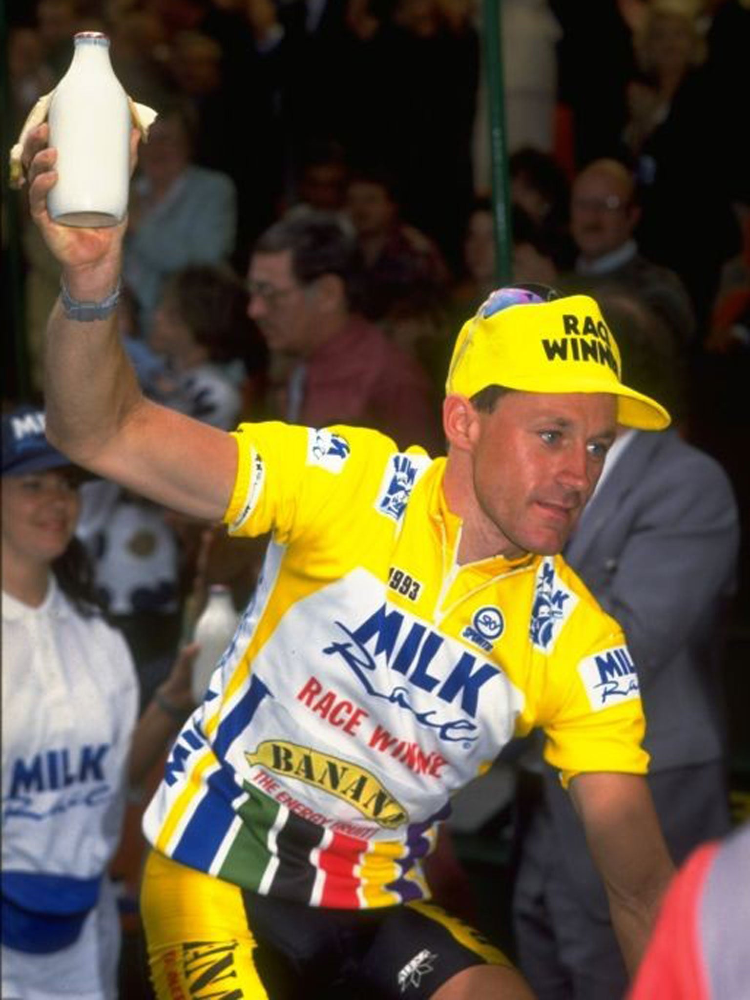 Chris Lillywhite, of Team Banana, grabs a pint of milk after winning the last Milk Race in 1993