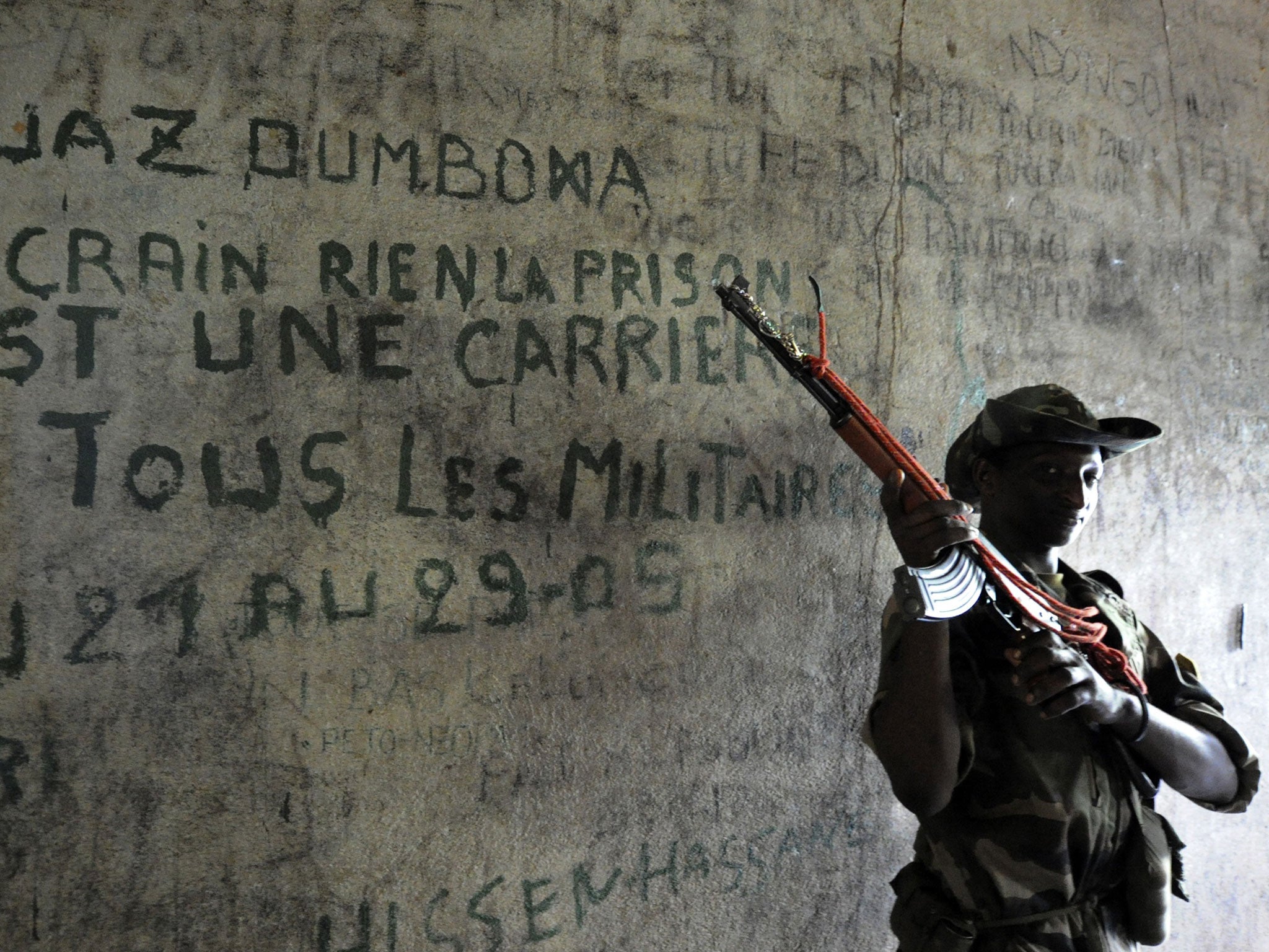 A rebel fighter guards a prison cell in Bangui
