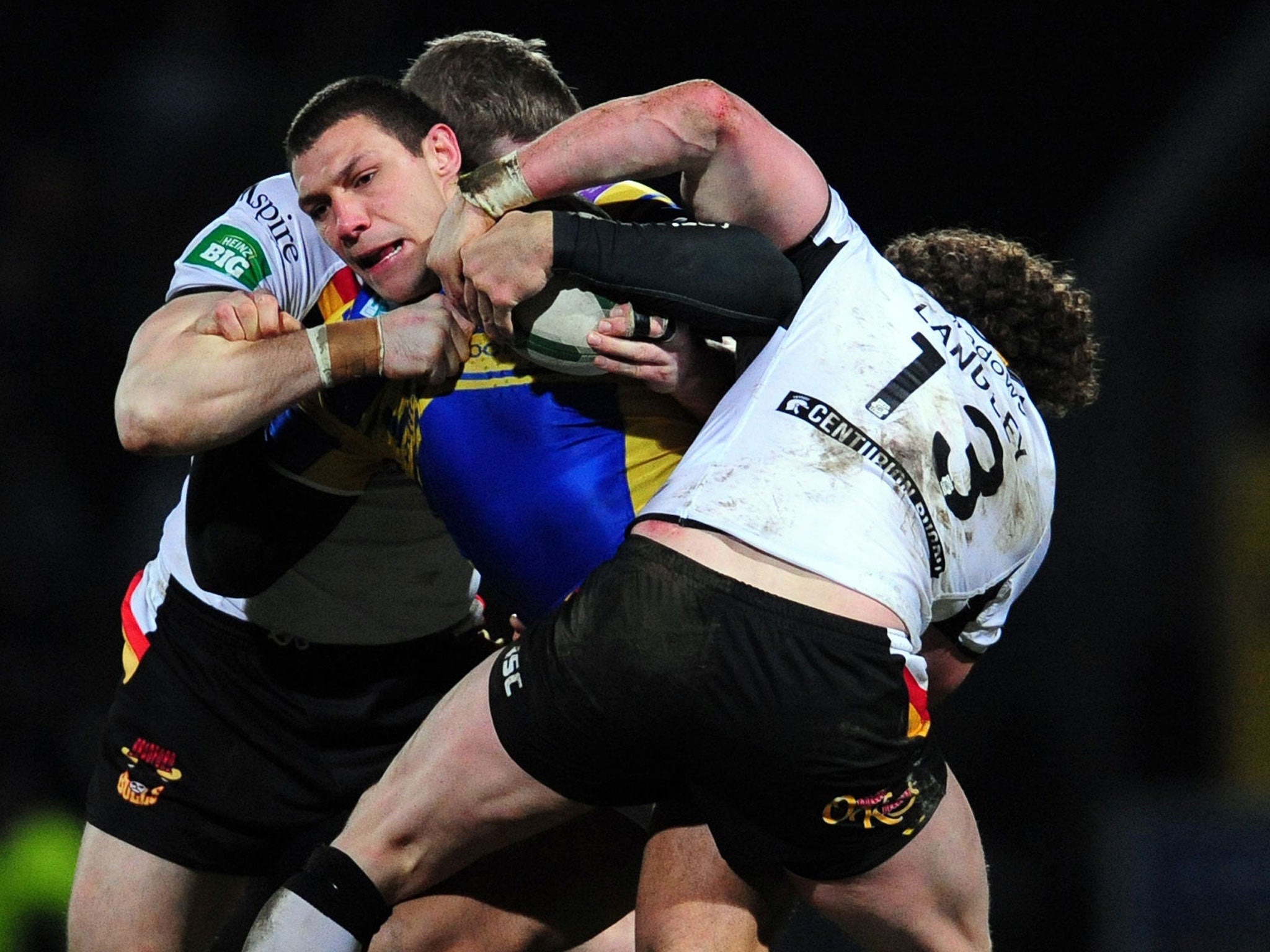 Ryan Hall, of Leeds, is held during the Rhinos’ draw with Bradford