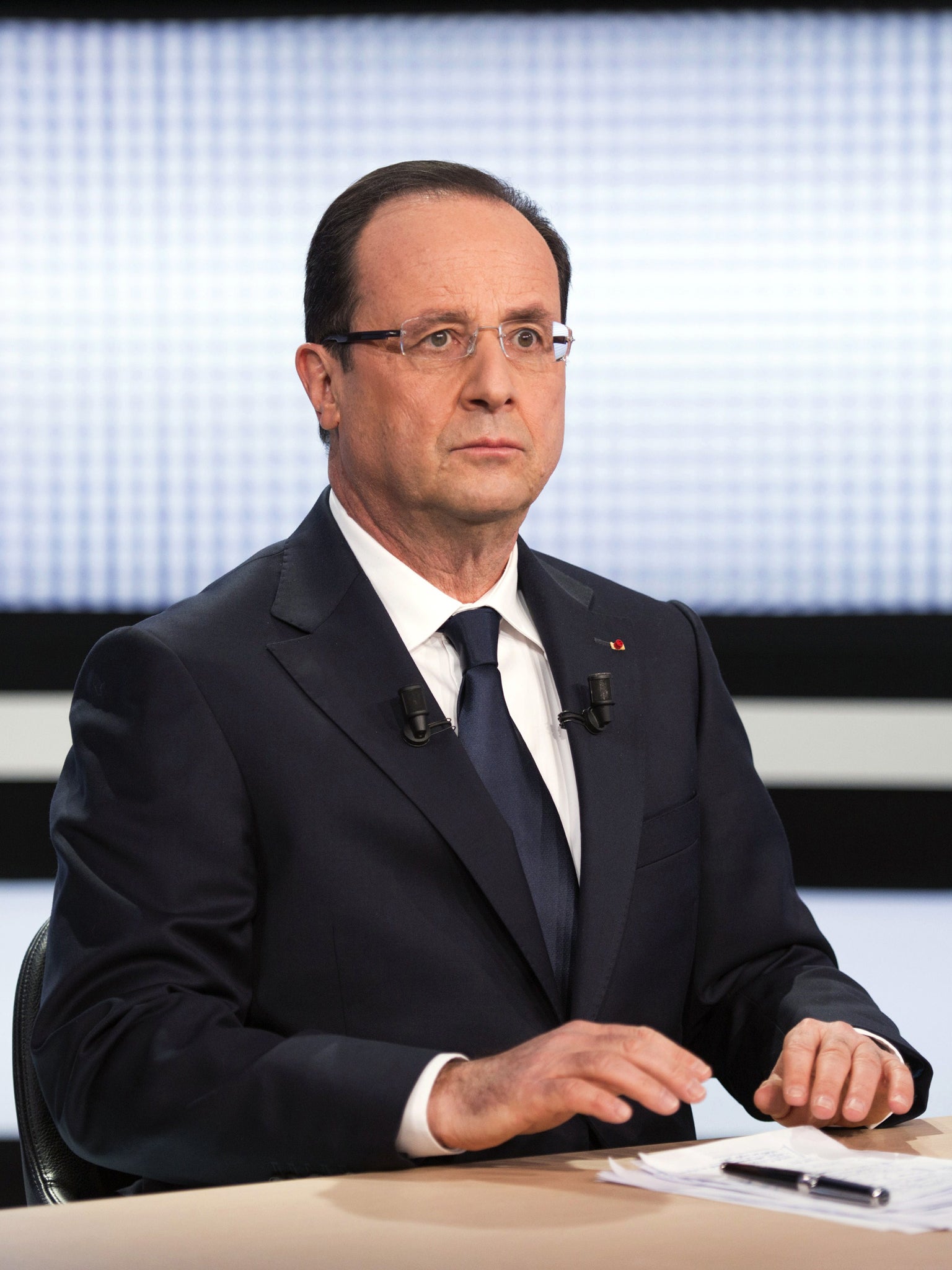 Beleaguered Franch president François Holland appears on TV