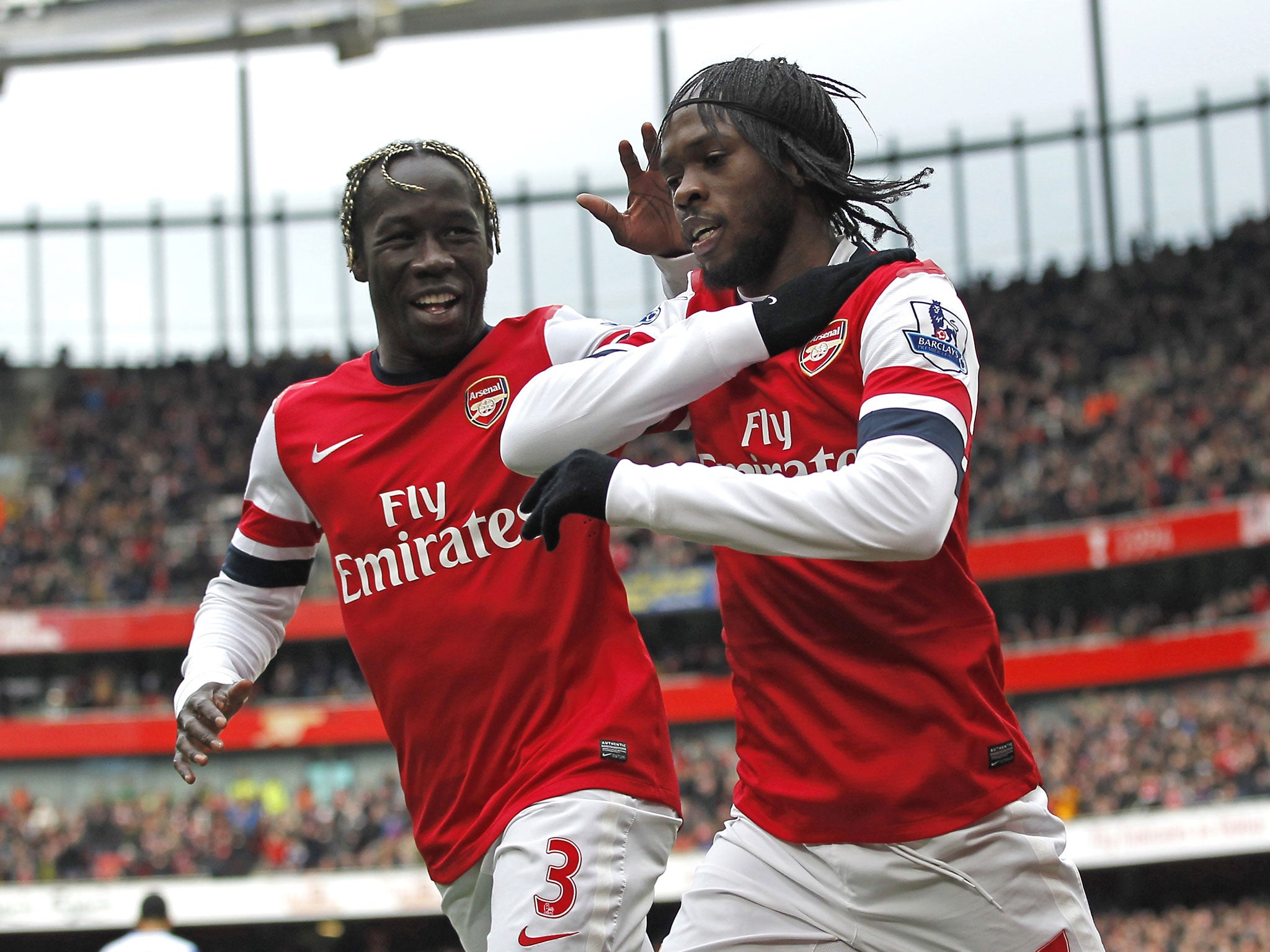 Arsenal's Ivorian striker Gervinho (R) celebrates scoring the opening goal with French defender Bacary Sagna