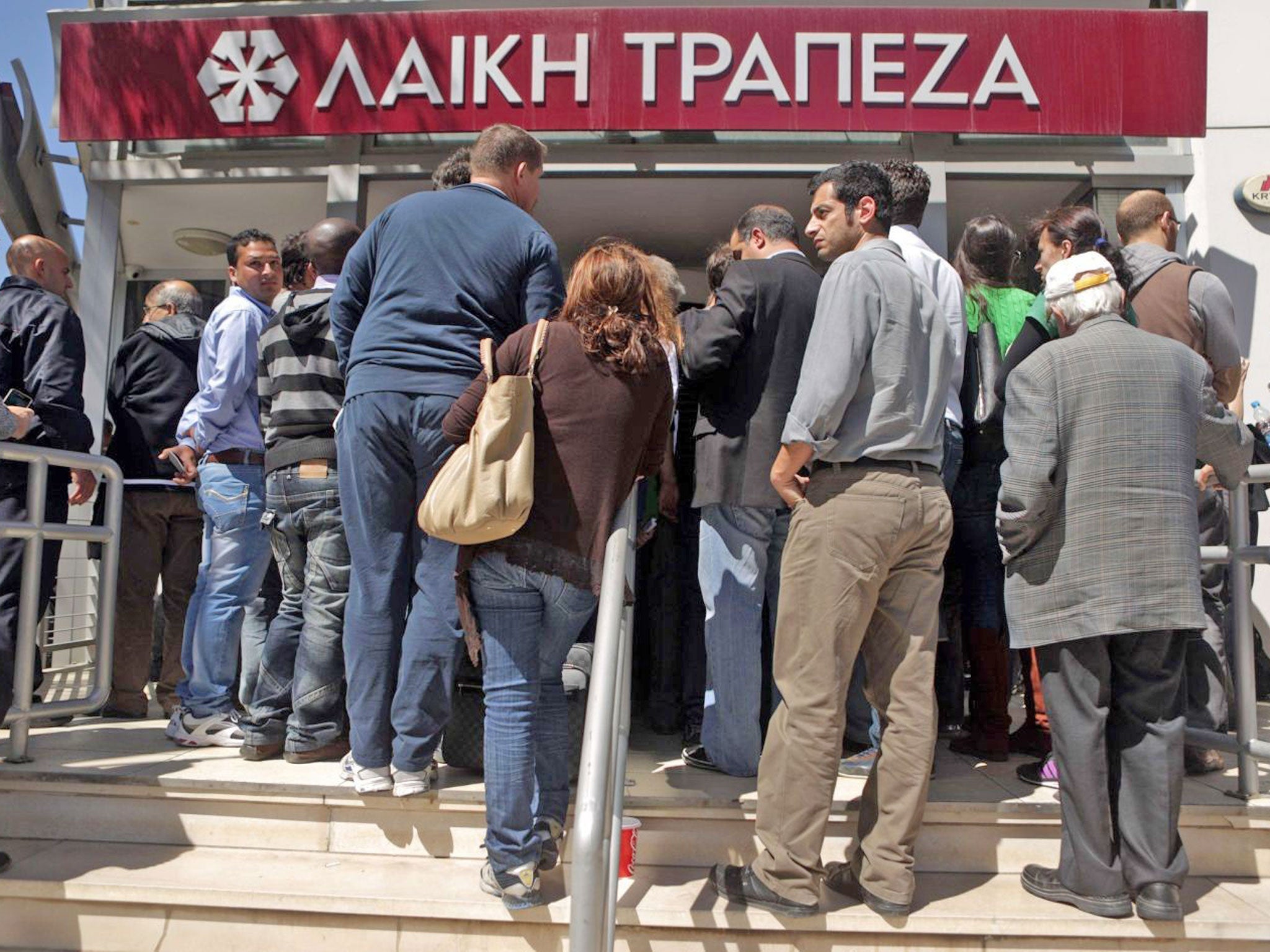 Cypriots outside a branch of Laiki Bank last week