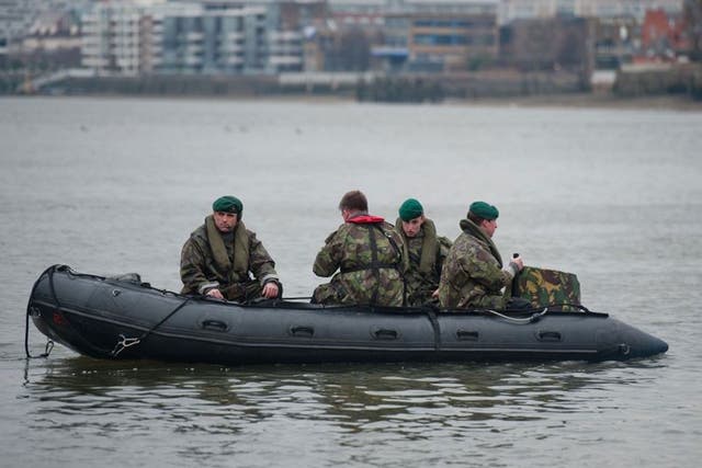 Royal Marines go through security preparation on the River Thames