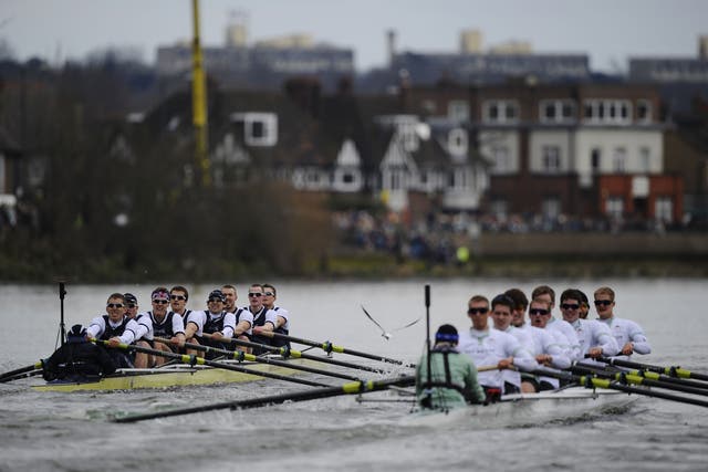 The Oxford University boat crew (L) competes against the Cambridge University crew during the annual boat race