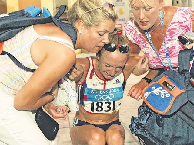 Paula Radcliffe is helped up after pulling out of the women’s marathon at the Athens Olympics