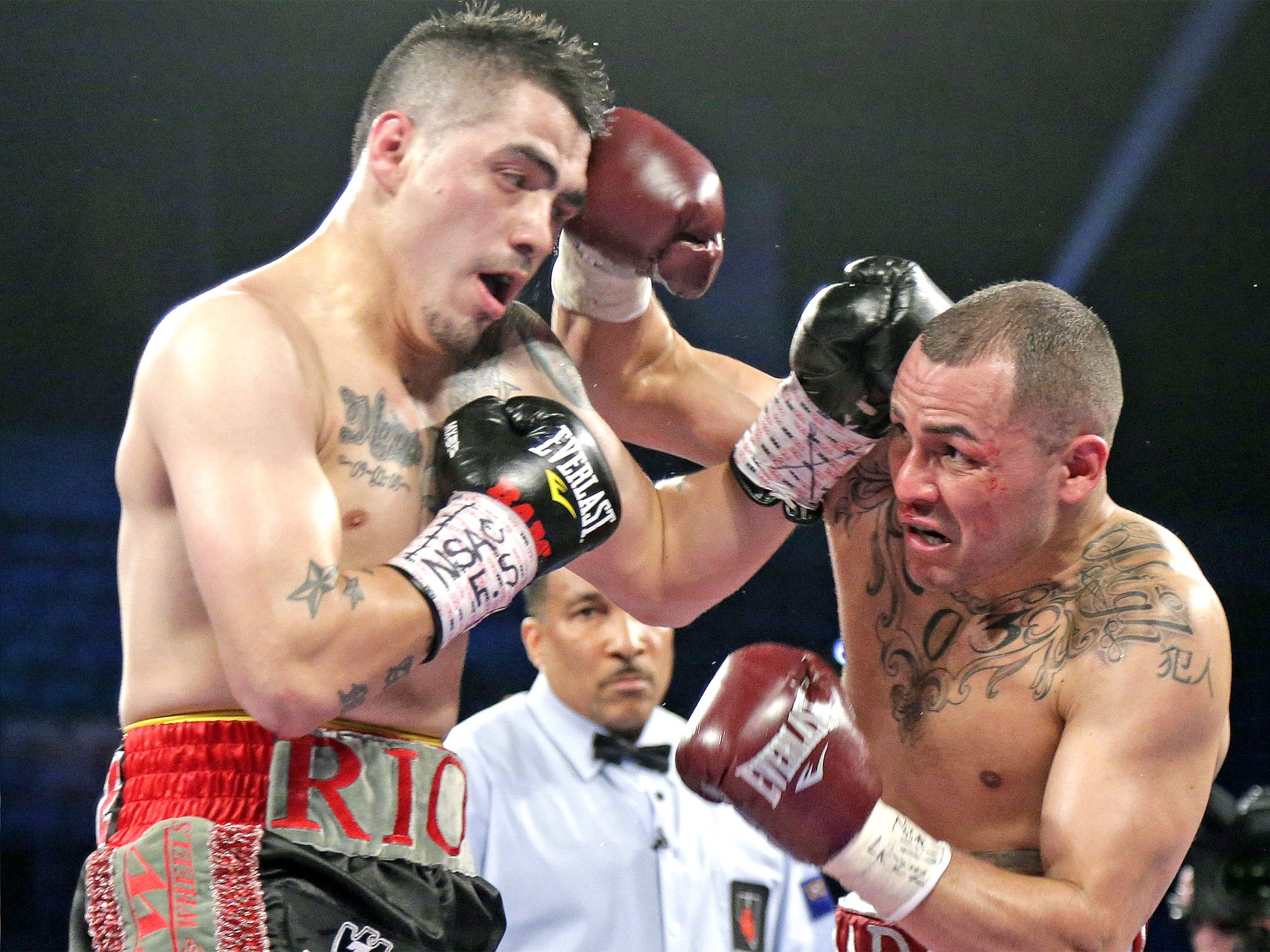 Mike Alvarado (right) exchanges punches with Brandon Rios during their 'slugfest' of a rematch in Las Vegas in 2013