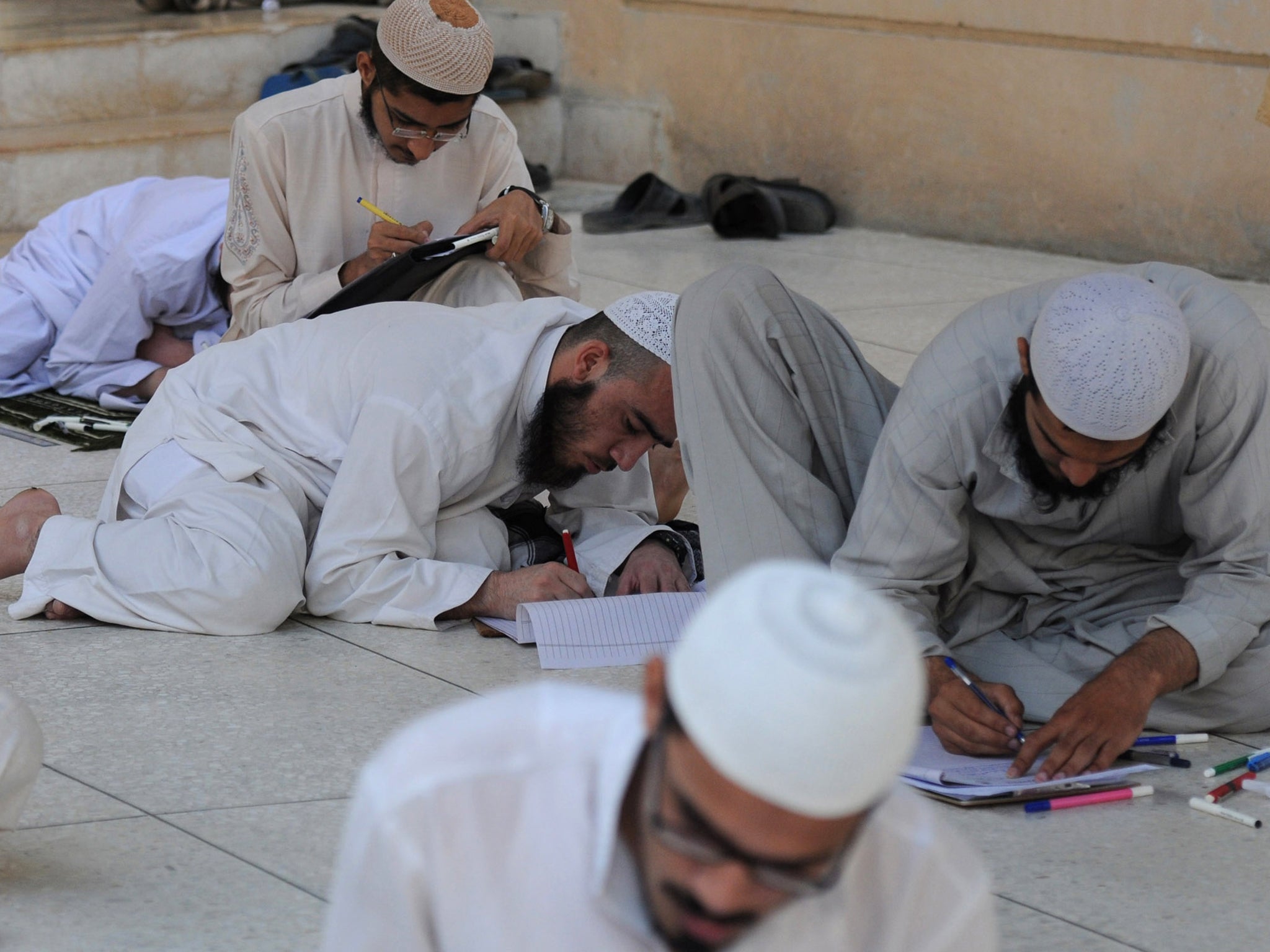 Pakistani youths take exams at an Islamic seminary in Karachi