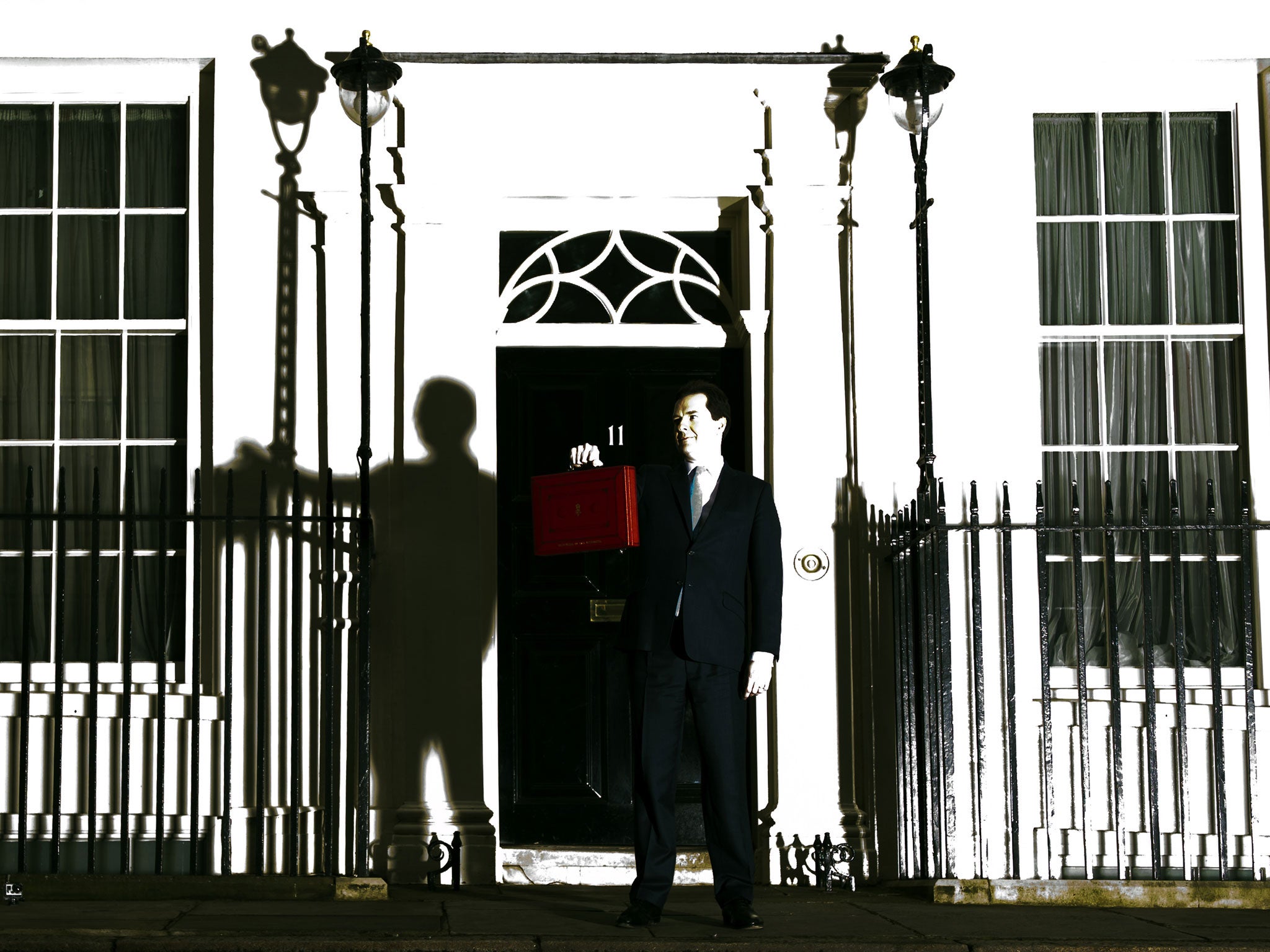 British Finance Minister George Osborne poses for pictures outside 11 Downing Street in London, on March 20, 2013, as he prepares to unveil the governments annual budget to parliament. (This image was taken using a remote camera that has caught a flash burst from a separate light source).