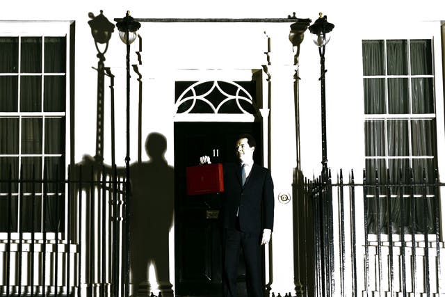 British Finance Minister George Osborne poses for pictures outside 11 Downing Street in London, on March 20, 2013, as he prepares to unveil the governments annual budget to parliament. (This image was taken using a remote camera that has caught a flash burst from a separate light source).