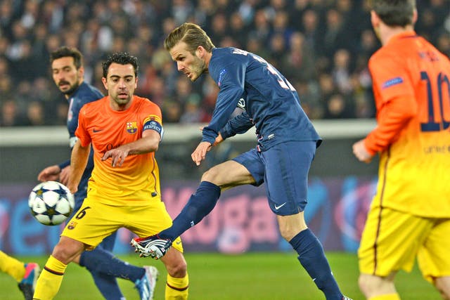 David Beckham goes past Xavi and Lionel Messi in Paris