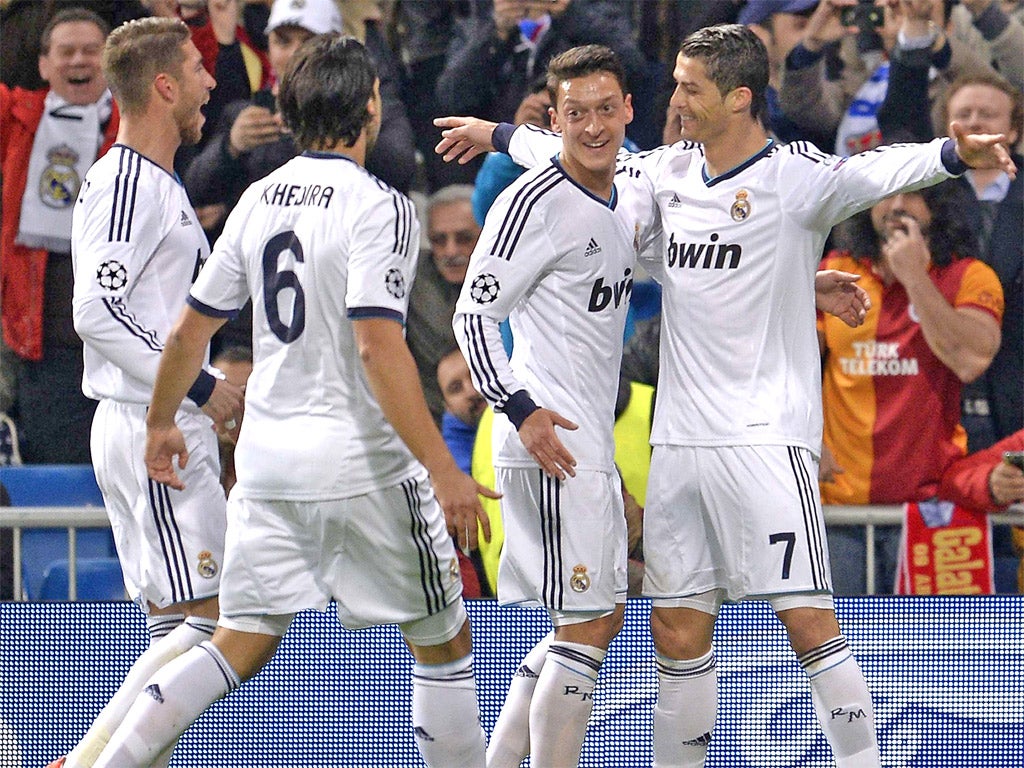 Real Madrid players celebrate with Cristiano Ronaldo after he set them on their way to a comfortable victory in the first leg
