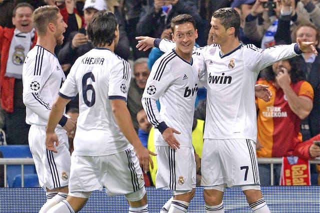 Real Madrid players celebrate with Cristiano Ronaldo after he set them on their way to a comfortable victory in the first leg