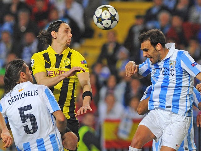 Dortmund's Neven Subotic vies with Malaga's Jesus Gamez in the first leg