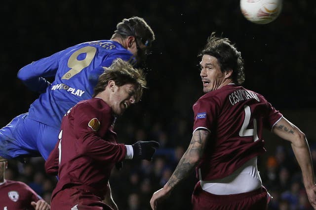 Fernando Torres rises above Rubin Kazan's Cristian Ansaldi to score his second goal