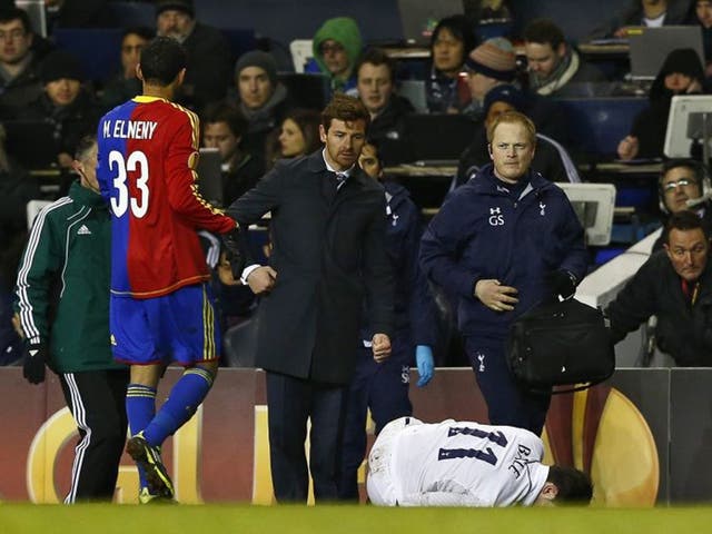 Andre Villas-Boas looks worried as Gareth Bale lies injured