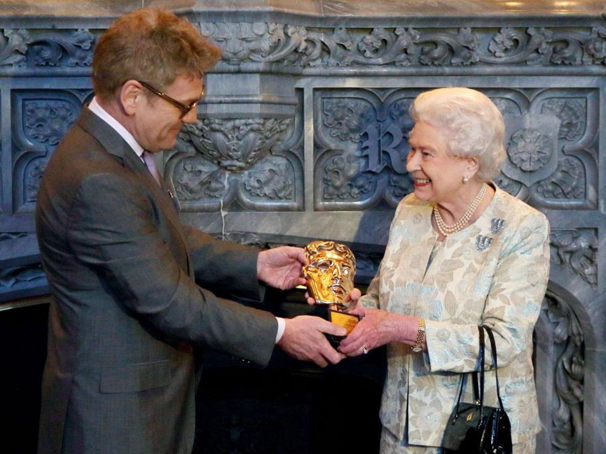 Sir Kenneth Branagh presents the Queen with her honorary Bafta award