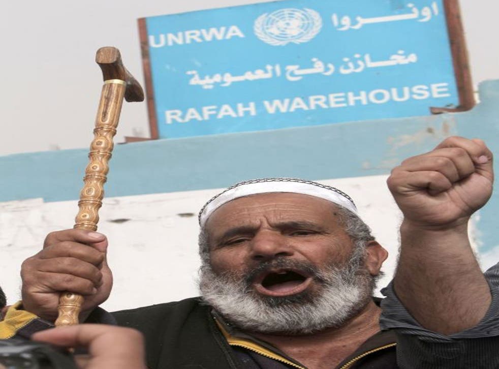 A Palestinian man protests against the reduction of some of the financial and food aid services given by the United Nations Relief and Works Agency