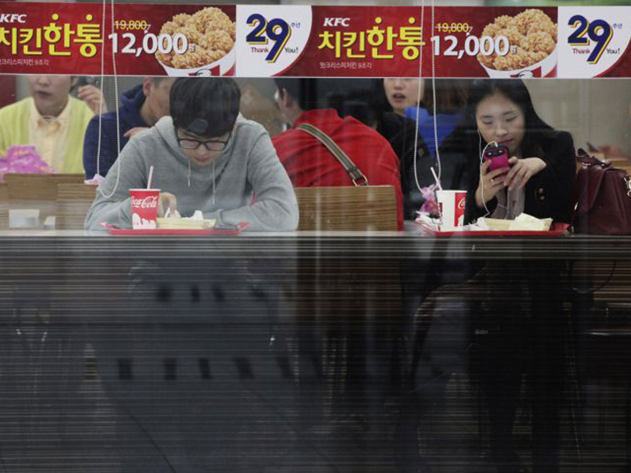 Office workers and shoppers throng the night-time streets of Seoul