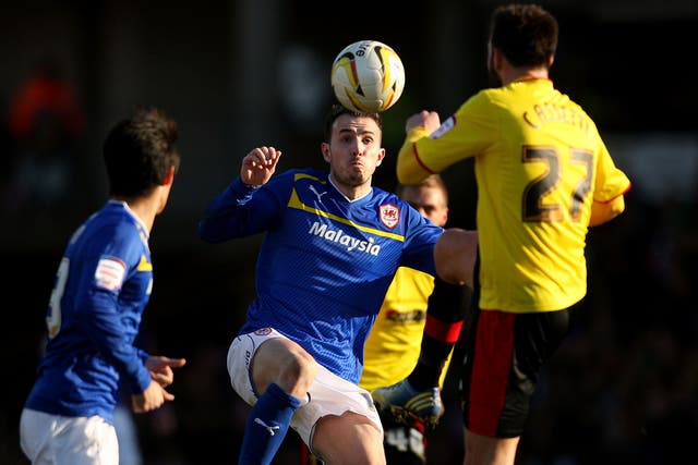 Kneesy does it: Mutch of Cardiff (left) tangles with Watford’s Cassetti