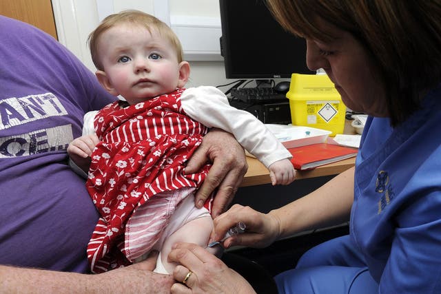 A 10-month-old girl has the MMR jab in Swansea yesterday