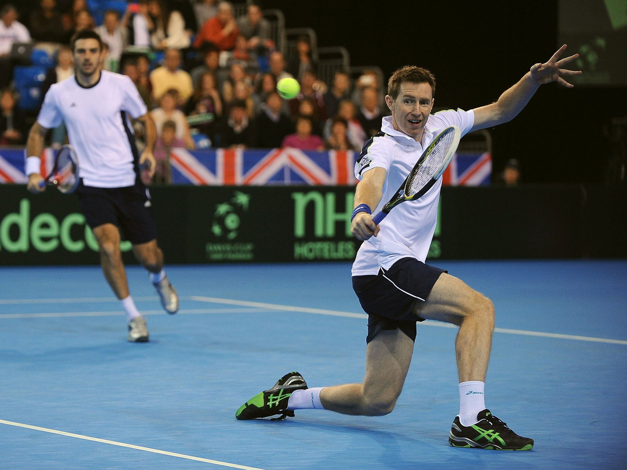 True brit: Jonny Marray plays a backhand watched by Colin Fleming on their way to a straight- sets victory